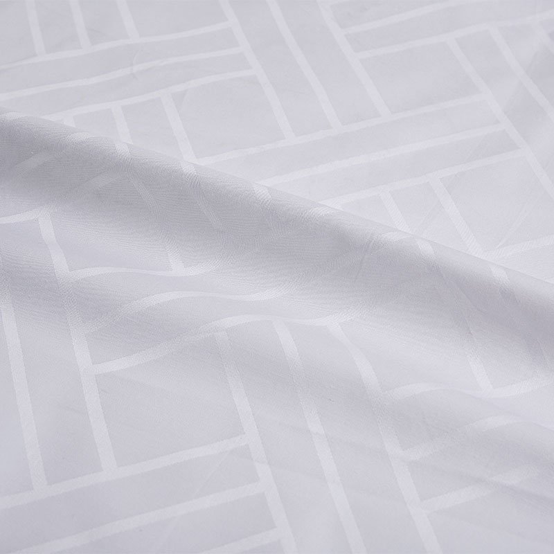 Ren bomullshvit vevd jacquard hotellark stoff